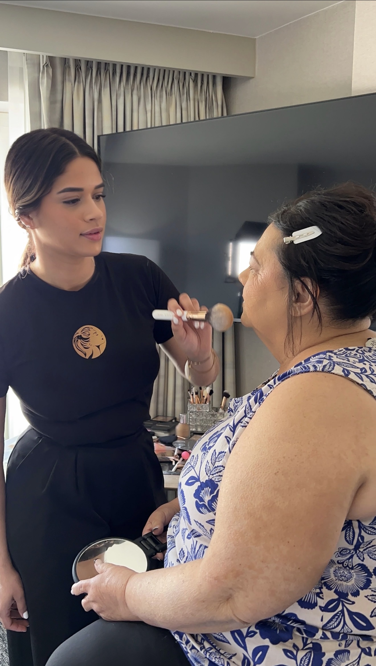 Dani applying makeup on location for a client, Blossom Beauty Studio by Dani, Clifton NJ